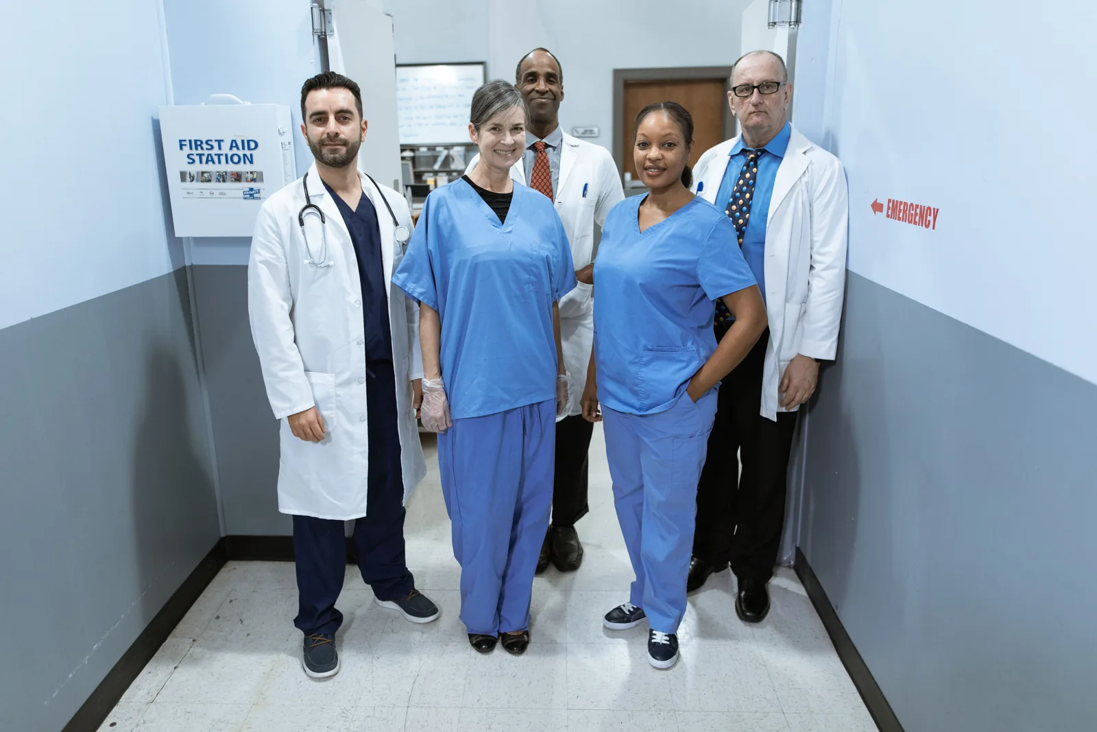 Diverse healthcare professionals standing together in a clinical environment